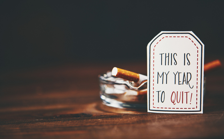 An ashtray beside a tag reading This is my year to quit